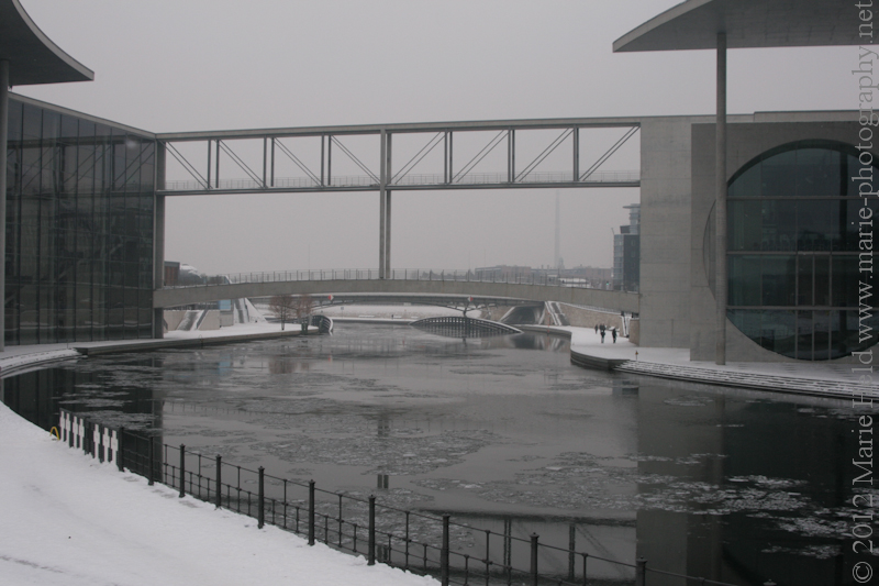 Icy river Spree flowing through the governmental complex.